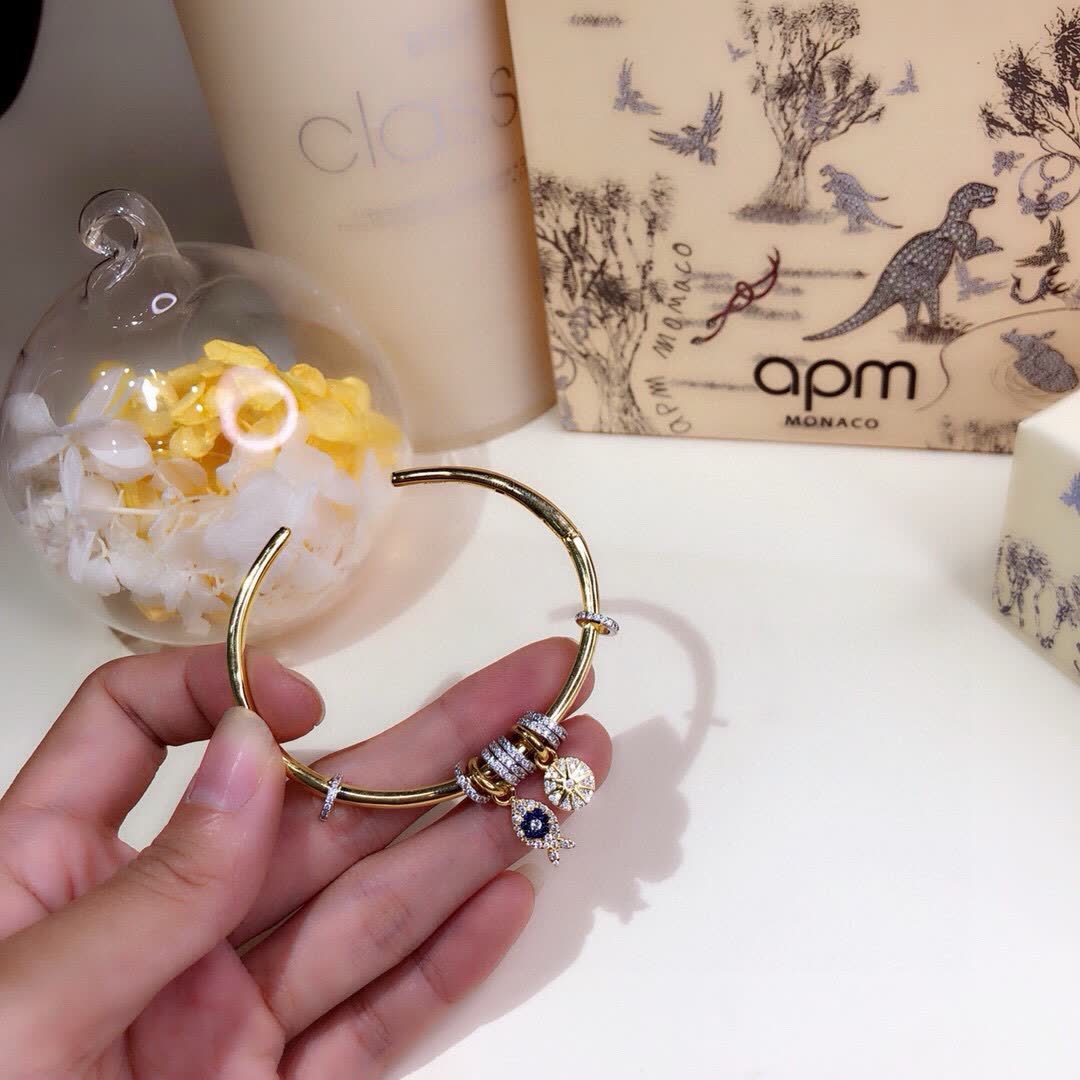 APM Monaco Gold Tone Bracelet with Fish and Star Charms